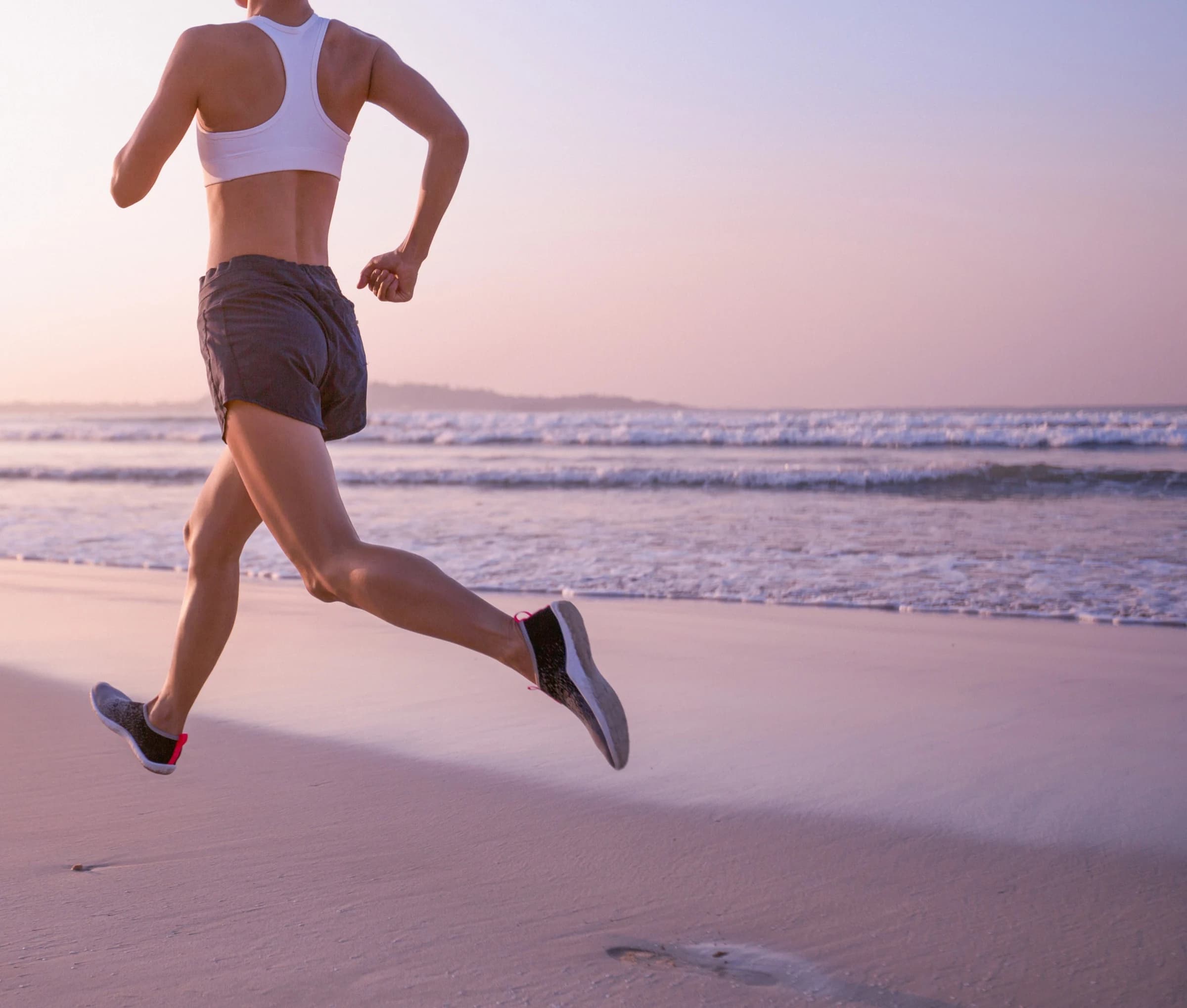 Runner moving confidently along a beach